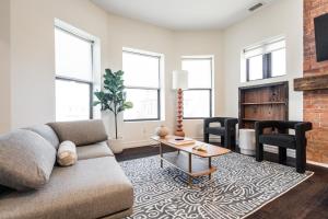 a living room with a couch and a fireplace at Mint House Detroit - Brush Park in Detroit