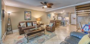 a living room with couches and a table at Villas by the Sea Resort & Conference Center in Jekyll Island