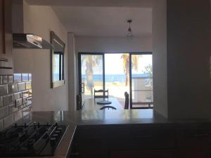 a kitchen with a stove and a view of the ocean at Seafront, 2 bed apartment in quiet central area in Pembroke +17 photos