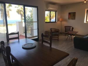 a dining room with a table and chairs and a living room at Seafront, 2 bed apartment in quiet central area in Pembroke