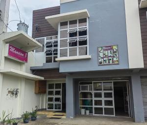 a building with a sign on the side of it at Mansion 8 Residences in Roxas City