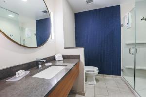 a bathroom with a sink and a toilet and a mirror at Fairfield Inn & Suites Marquette in Marquette