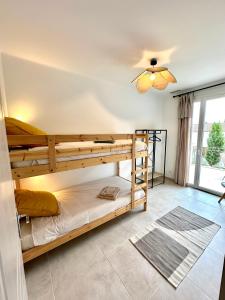 a bedroom with two bunk beds and a ceiling fan at Villa Saint Jean En Provence in Châteaurenard