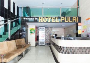 a hotel lobby with a welcome to hotel pula at Hotel Pulai Ipoh in Ipoh