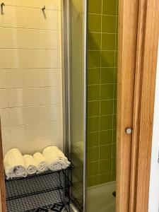 a shower with towels on a rack in a bathroom at Smart Living in Aveiro