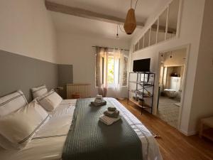 1 dormitorio con 1 cama con toallas en Mas des Bambous, en Saint-Rémy-de-Provence