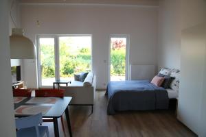 a bedroom with a bed and a living room at Apartmány Hluboká nad Vltavou s výhledem na zámek in Hluboká nad Vltavou