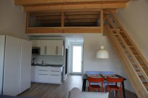 a kitchen and dining room with a loft at Apartmány Hluboká nad Vltavou s výhledem na zámek in Hluboká nad Vltavou