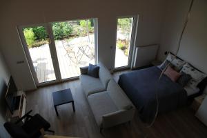 a living room with a couch and a bed at Apartmány Hluboká nad Vltavou s výhledem na zámek in Hluboká nad Vltavou