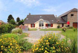 Chez soule في Riupeyrous: منزل مع حديقة بها زهور صفراء