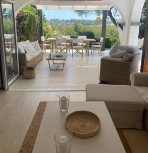 a living room with a table in the middle of a room at Las Pergolas in Marbella