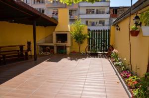 a courtyard with a fireplace in a building at Edelvais Guest House in Primorsko