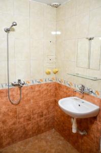 a bathroom with a sink and a shower at Edelvais Guest House in Primorsko +55 photos