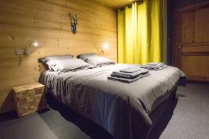 een slaapkamer met een groot bed in een houten muur bij HaKaJu Appartement 10 personnes à Val Cenis in Lanslebourg-Mont-Cenis