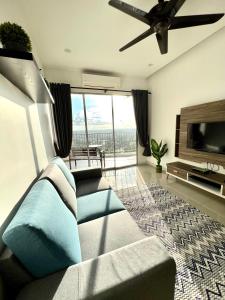 a living room with a couch and a flat screen tv at Home Away From Home In Taiping - Newly Upgraded! in Taiping