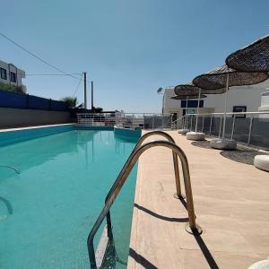 a swimming pool with a stairway in the water at Başaran tatil evleri in Milas