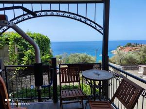 a balcony with a table and chairs and the ocean at Apartmani Fortunela in Sveti Stefan