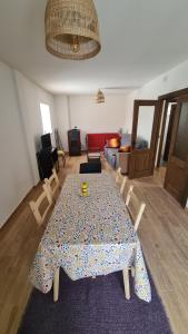a living room with a table and chairs and a couch at Apartamentos Casa de los Ramos in Vinuesa