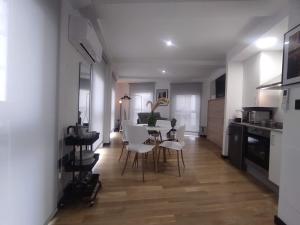 eine Küche und ein Esszimmer mit Tisch und Stühlen in der Unterkunft 1B. Estudio muy luminoso en el corazón del tapeo. in Ourense