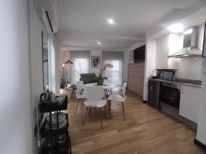 eine Küche und ein Esszimmer mit Tisch und Stühlen in der Unterkunft 1B. Estudio muy luminoso en el corazón del tapeo. in Ourense + 4 Fotos