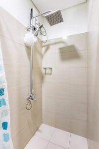 a bathroom with a shower with a shower curtain at Cozy Staycation Shore 2 Residences Tower 2 in Manila