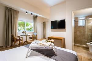 a hotel room with a bed and a bathroom at Villy's Comfort Zone Apartments in Kalamata