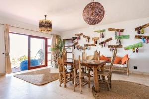 a dining room with a wooden table and chairs at Beachwood Camps Bay in Cape Town