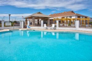 a large pool with blue water in front of a building at Holiday Inn Express Kitty Hawk - Outer Banks, an IHG Hotel in Kitty Hawk