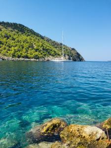 a sail boat in the water near a island at The Cove Assos in Asos
