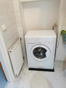 a washer and dryer in a corner of a bathroom at Patrik apartman in Székesfehérvár