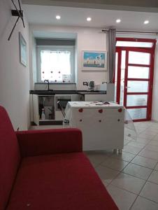a living room with a couch and a table at Neruda Chic House Sant'Angelo in Sant'Angelo D'Ischia