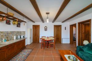 a kitchen and dining room with a table and chairs at AMA Guest House in Turda
