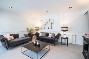 a living room with two couches and a coffee table at Luxury villa in El Sardinero in Santander