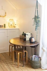a kitchen with a wooden table and a tableablish at Charmant cocon centre historique in Besançon