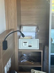 a drawer with a box in a wooden cabinet at Itaipava Granja Brasil Studio in Itaipava