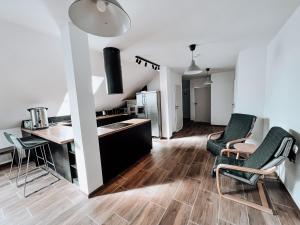 a kitchen and living room with a table and chairs at Zacisze in Karczmiska