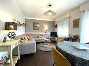 a living room with a couch and a table at La barthe in Biarritz
