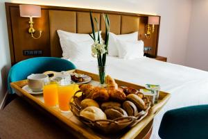 uma bandeja de comida de pequeno-almoço numa mesa num quarto de hotel em Hotel Premium Chaves - Aquae Flaviae em Chaves