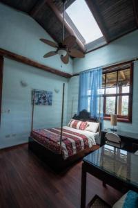 a bedroom with a bed and a ceiling fan at Vilcabamba casa / granja Vilcabamba house / farm in Loja