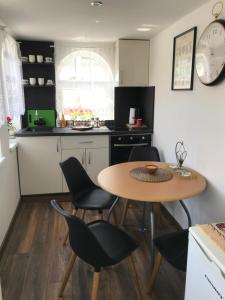 a kitchen with a table and chairs in a kitchen at Vila Juliana in Kostol