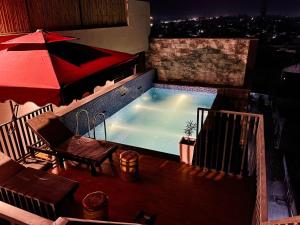 a swimming pool on top of a building at Hotel Euphoria Green in Amritsar