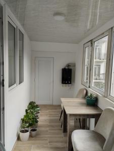 a room with a table and chairs and plants at Guest house number 1 in Batumi