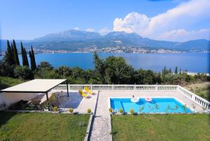 a swimming pool with a view of a lake at Mountain Bay View Apartments in Njivice +42 photos