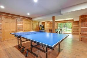 a ping pong table in a room with wooden cabinets at Custom-Built Clarklake Cabin Sauna and Cold Plunge! in Clarklake