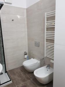 a bathroom with a white toilet and a sink at Main square apartment in Durrës