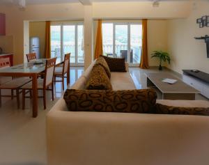 a living room with a couch and a table at Mountain Bay View Apartments in Njivice