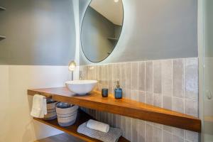 a bathroom with a sink and a mirror at Sitges Spaces Mediterranean Penthouse in Sitges +19 photos