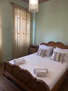 a bedroom with a large bed with towels on it at Angolo del Centro in Ágios Rókkos
