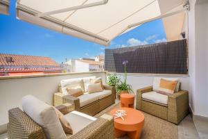 a balcony with two chairs and a table at Sitges Spaces Mediterranean Penthouse in Sitges