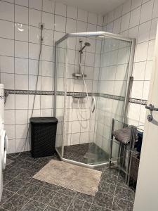 a shower with a glass enclosure in a bathroom at Bergen Bliss: Mountain View in Bergen